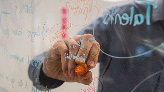 person drawing on glass 