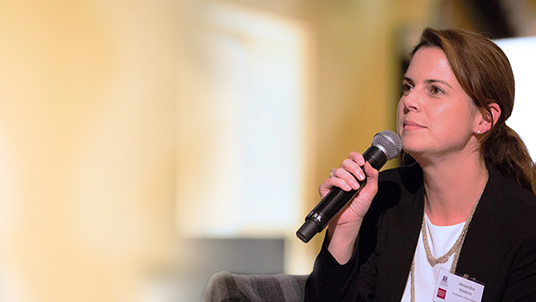 Organisational learning event presenter with microphone