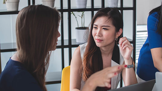 Organisational roundtable discussions between two women 